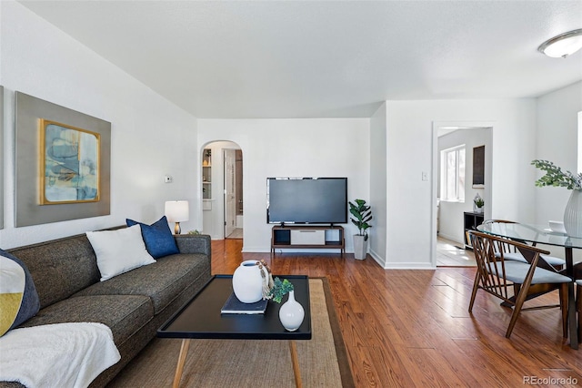 4740 Milwaukee St, Denver, CO 80216 - living room featuring arched walkways, wood finished floors, and baseboards