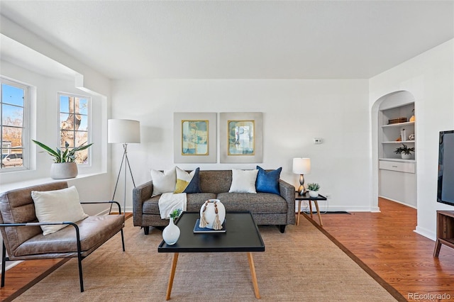 4740 Milwaukee St, Denver, CO 80216 - living area with wood finished floors, baseboards, and built in shelves