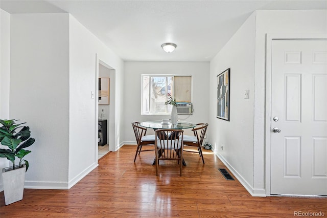 4740 Milwaukee St, Denver, CO 80216 - dining area featuring wood finished floors, baseboards, and cooling unit