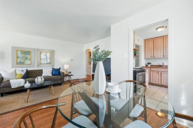4740 Milwaukee St, Denver, CO 80216 - dining space featuring arched walkways and light tile patterned floors