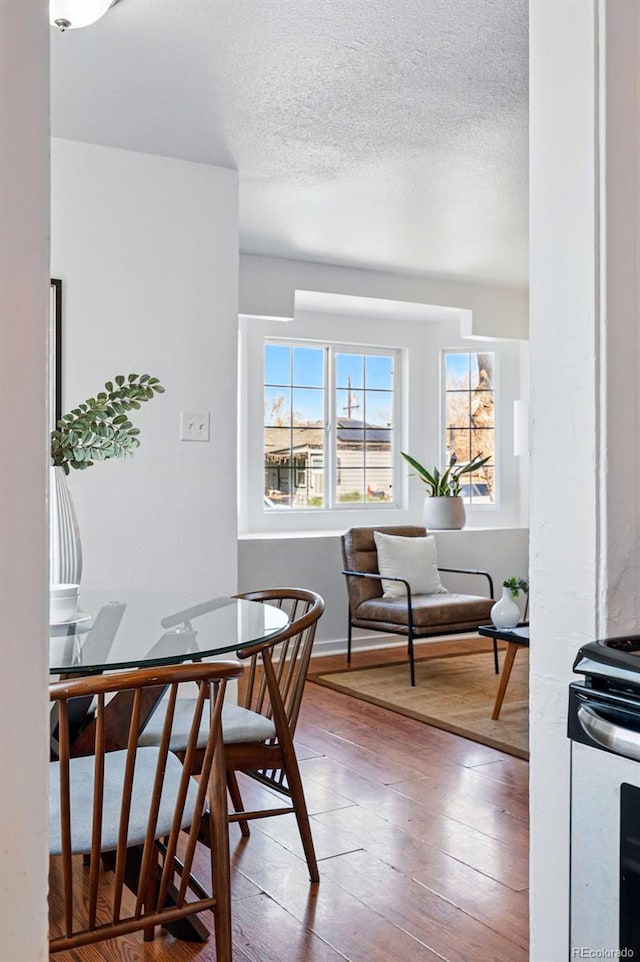 4740 Milwaukee St, Denver, CO 80216 - dining space with hardwood / wood-style floors, baseboards, and a textured ceiling