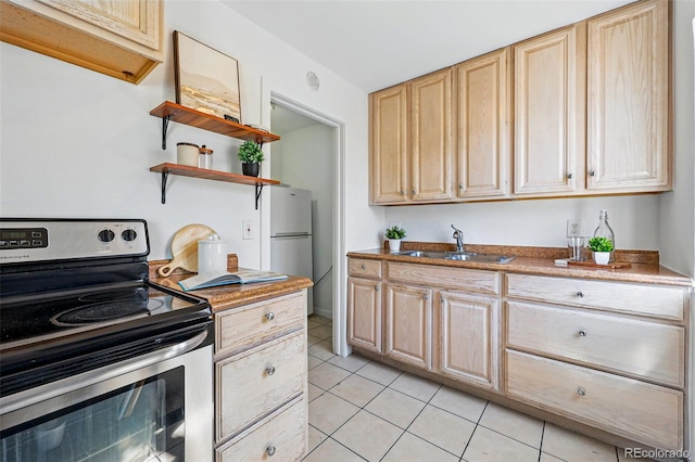 4740 Milwaukee St, Denver, CO 80216 - kitchen with electric range, a sink, light brown cabinetry, light tile patterned flooring, and freestanding refrigerator