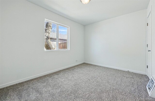 4740 Milwaukee St, Denver, CO 80216 - carpeted spare room featuring baseboards