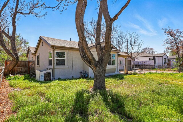 4740 Milwaukee St, Denver, CO 80216 - rear view of house featuring stucco siding and fence