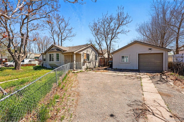 4740 Milwaukee St, Denver, CO 80216 - view of front facade featuring stucco siding, asphalt driveway, and a detached garage