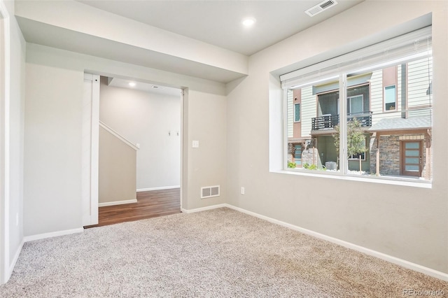 carpeted empty room with baseboards and recessed lighting
