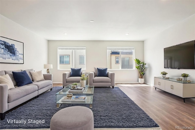 living area with plenty of natural light, wood finished floors, baseboards, and recessed lighting