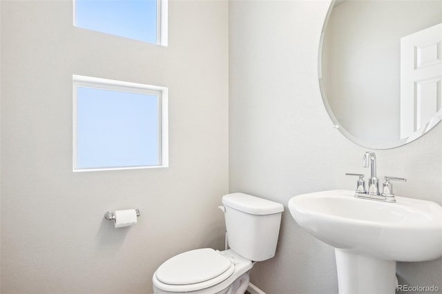 bathroom with toilet and a sink
