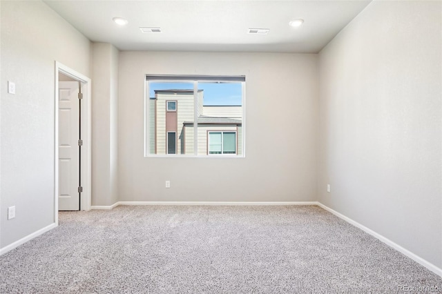 empty room featuring carpet flooring, baseboards, and recessed lighting
