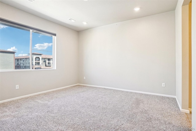 unfurnished room with carpet floors, baseboards, and recessed lighting