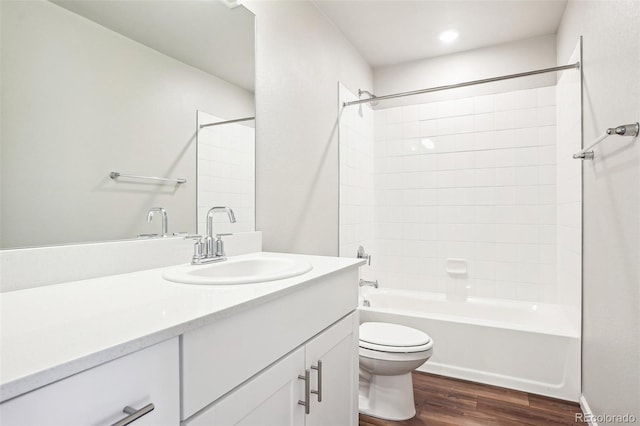 full bath with wood finished floors, toilet, vanity, shower / tub combination, and recessed lighting