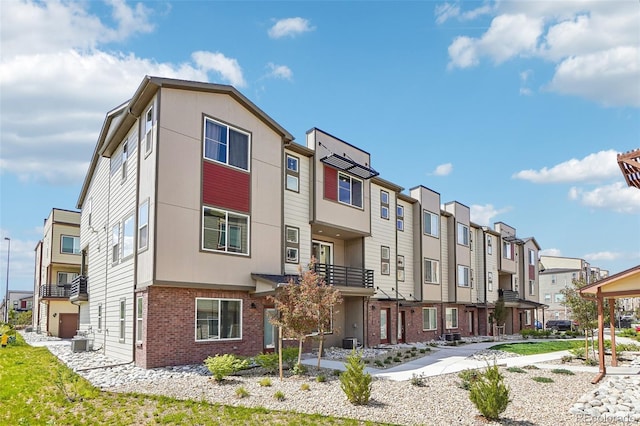 view of building exterior with a residential view and central AC