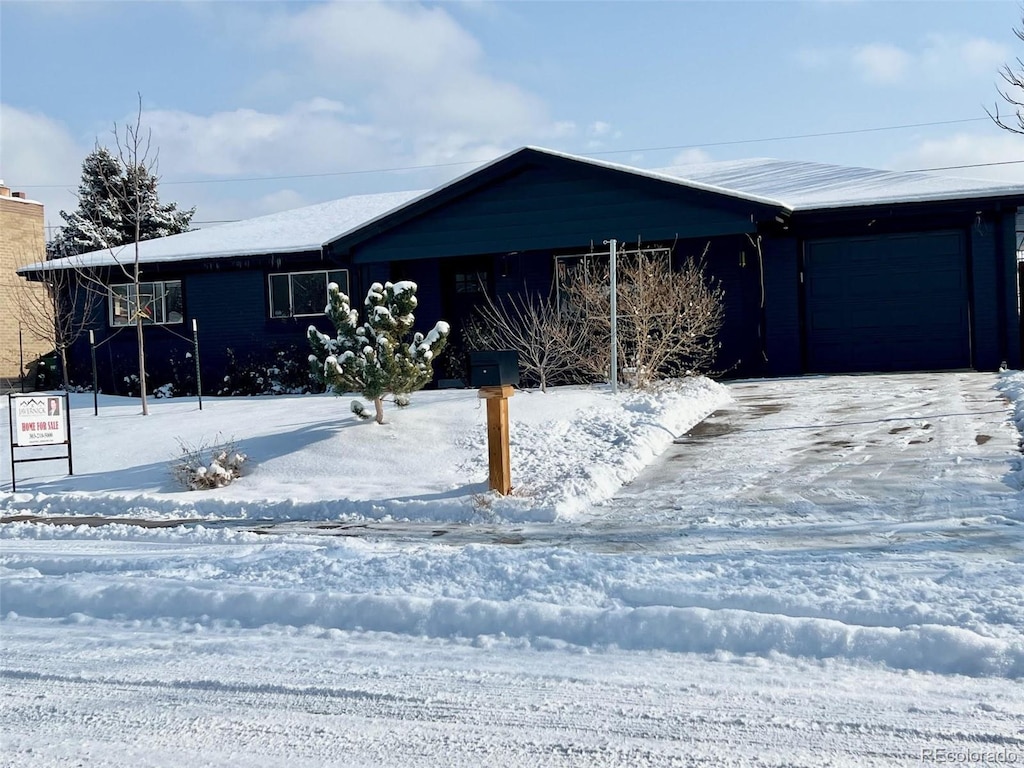 ranch-style home featuring a garage