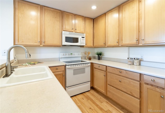 kitchen with sink, white appliances, light hardwood / wood-style floors, and light brown cabinets