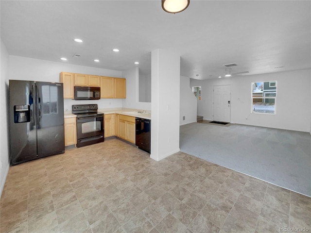 kitchen featuring recessed lighting, open floor plan, light countertops, light brown cabinetry, and black appliances