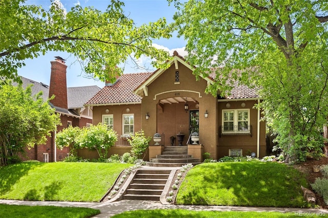 615 N Williams St, Denver, CO 80218 - mediterranean / spanish house with a front lawn, stucco siding, a chimney, and stairs