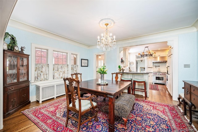 615 N Williams St, Denver, CO 80218 - dining area with radiator, a chandelier, and wood finished floors
