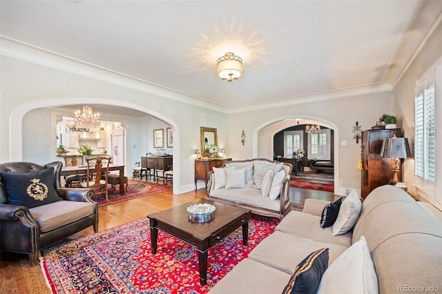 615 N Williams St, Denver, CO 80218 - living room featuring arched walkways, a chandelier, wood finished floors, plenty of natural light, and crown molding