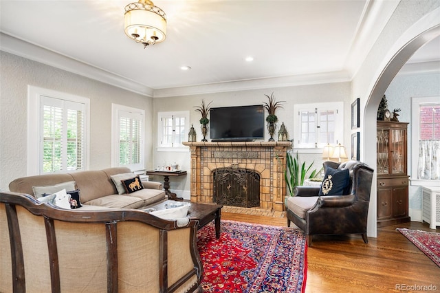 615 N Williams St, Denver, CO 80218 - living area with arched walkways, wood finished floors, crown molding, a fireplace, and a textured wall