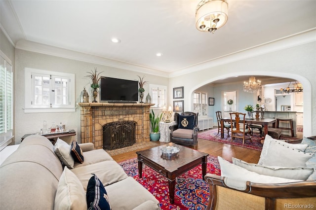 615 N Williams St, Denver, CO 80218 - living room with arched walkways, a chandelier, wood finished floors, crown molding, and a fireplace