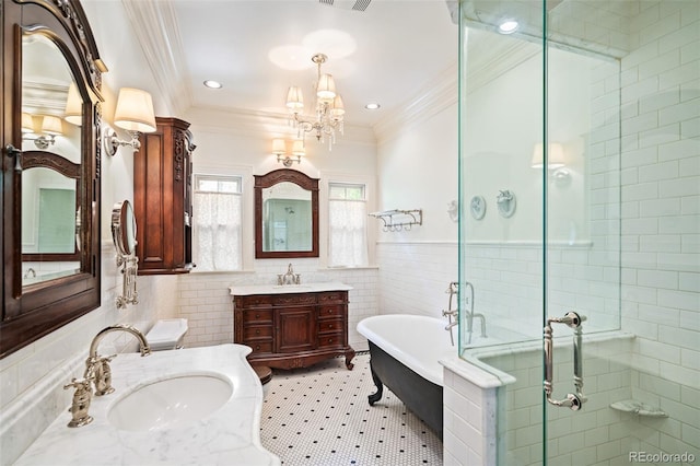 615 N Williams St, Denver, CO 80218 - full bath featuring tile walls, a stall shower, a soaking tub, crown molding, and two vanities