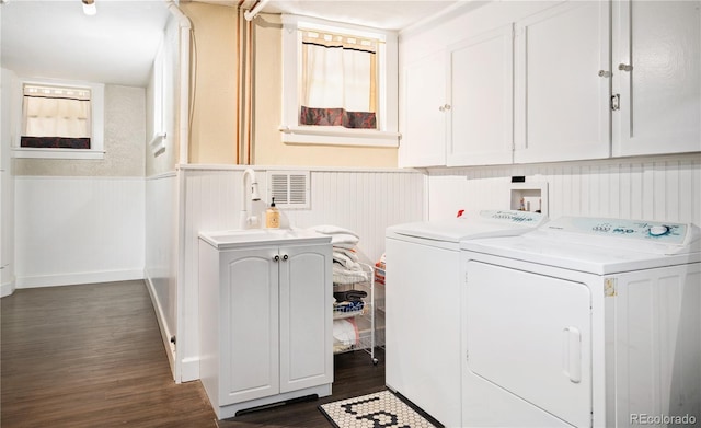 615 N Williams St, Denver, CO 80218 - laundry room with washing machine and dryer, wainscoting, dark wood-style flooring, cabinet space, and a decorative wall