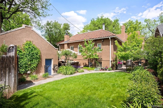 615 N Williams St, Denver, CO 80218 - rear view of property with a chimney, stucco siding, and a tile roof