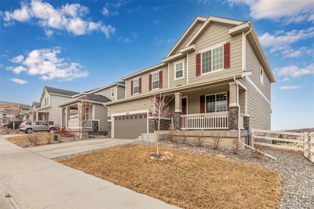 craftsman inspired home with a garage and covered porch