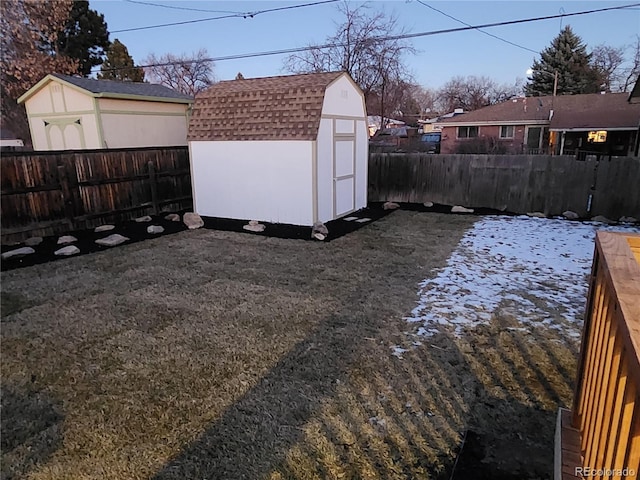 yard covered in snow with a storage unit