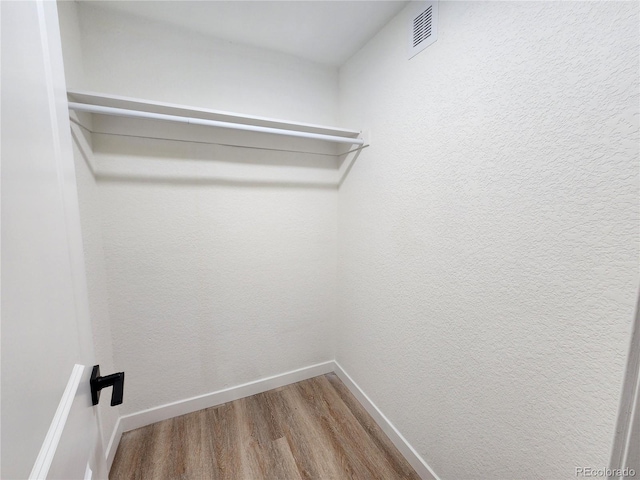 walk in closet featuring hardwood / wood-style floors