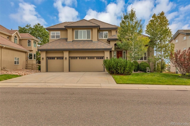 view of front of house featuring a front yard and a garage