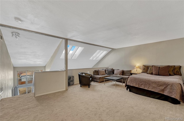 bedroom with vaulted ceiling with skylight, carpet, and a textured ceiling