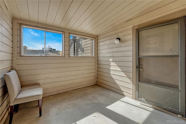 unfurnished sunroom featuring wooden ceiling