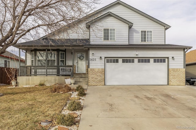 view of front of house with a garage, a front lawn, and covered porch