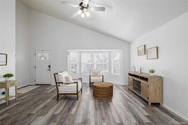 sitting room featuring ceiling fan, high vaulted ceiling, and dark hardwood / wood-style flooring