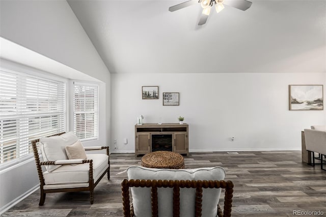 living room with ceiling fan, a fireplace, dark hardwood / wood-style flooring, and vaulted ceiling