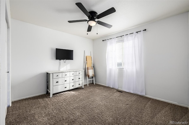 unfurnished bedroom with dark carpet and ceiling fan