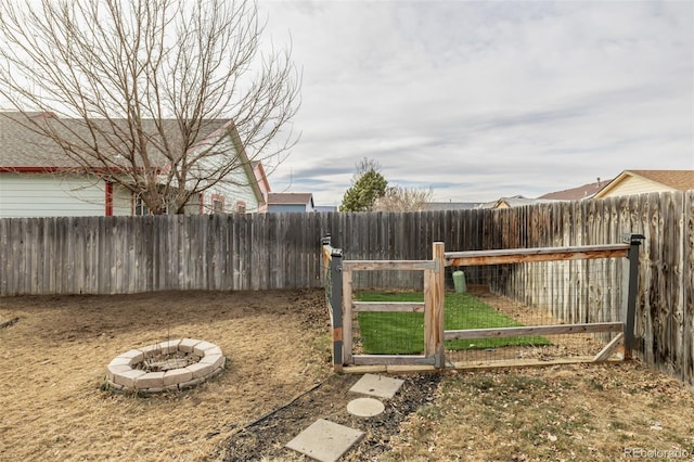 view of yard with a fire pit