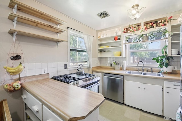 1975 Cody St, Lakewood, CO 80215 - kitchen featuring stainless steel appliances, open shelves, white cabinets, and decorative backsplash