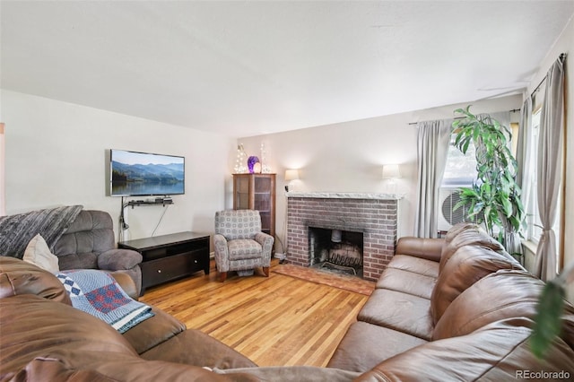 1975 Cody St, Lakewood, CO 80215 - living area featuring wood finished floors and a brick fireplace