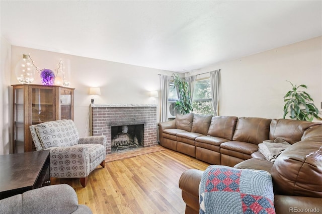 1975 Cody St, Lakewood, CO 80215 - living area with light wood-style floors and a brick fireplace