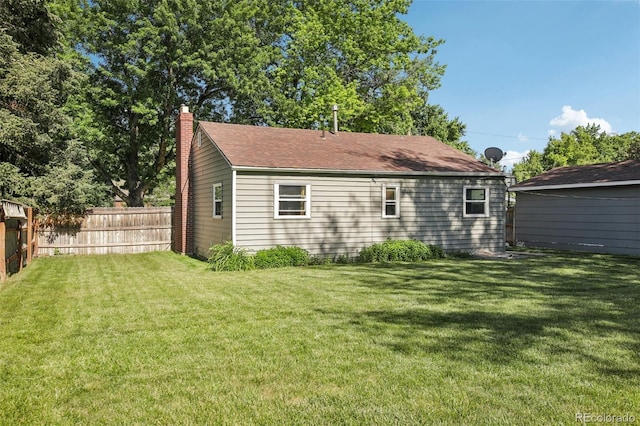 1975 Cody St, Lakewood, CO 80215 - rear view of property featuring a chimney and a shingled roof