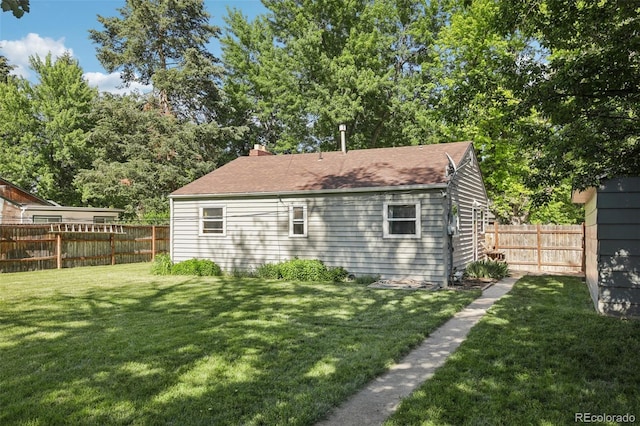 1975 Cody St, Lakewood, CO 80215 - rear view of house featuring a fenced backyard and a chimney