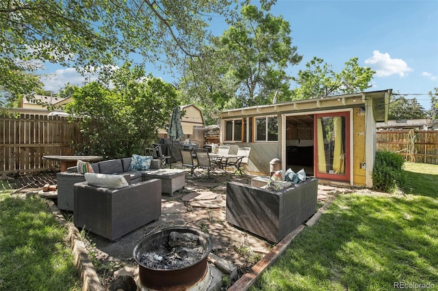 1975 Cody St, Lakewood, CO 80215 - fenced backyard with an outdoor living space with a fire pit, a patio, outdoor dining space, and an outbuilding