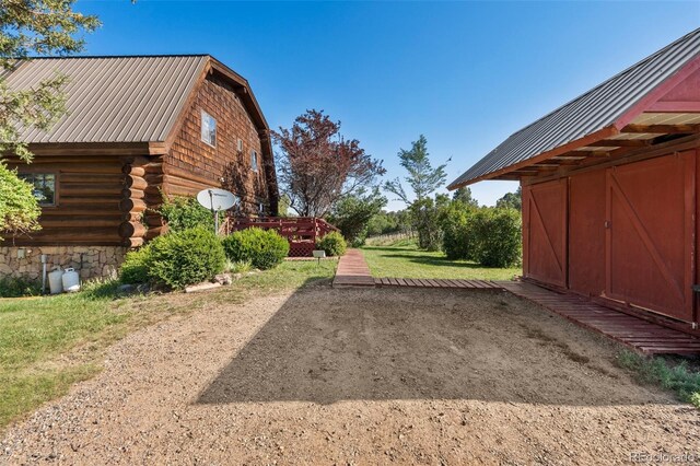 view of property exterior with a storage shed and a wooden deck