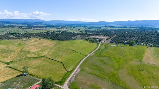 birds eye view of property featuring a mountain view and a rural view