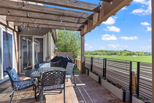 view of patio featuring outdoor dining area, a pergola, fence, and grilling area