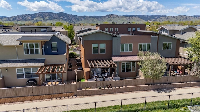 3734 Ridgeway St, Boulder, CO 80301 - back of house featuring a pergola, a mountain view, a residential view, and a fenced backyard