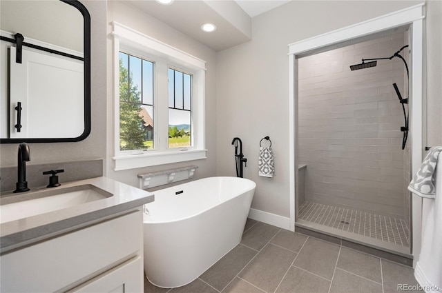 bathroom with tile patterned floors, vanity, and separate shower and tub