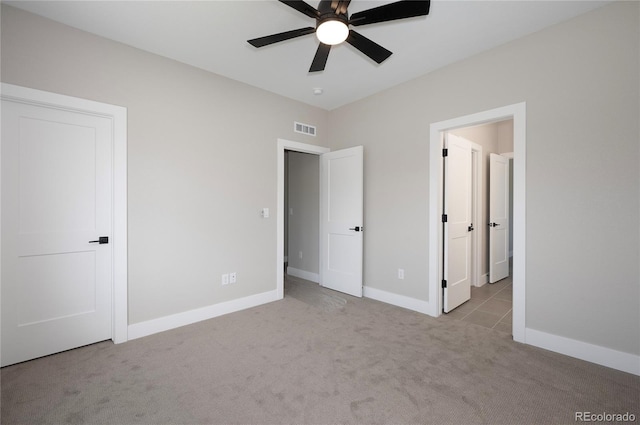 unfurnished bedroom with light carpet and ceiling fan